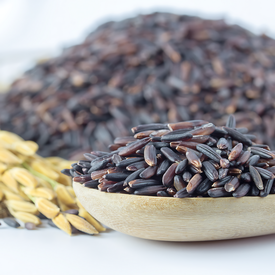 Black rice in a wooden spoon